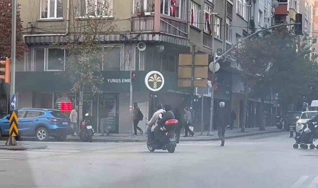 Kasksız kucağında bebekle kırmızı ışığa rağmen elektrikli bisiklet ile yoluna devam ettiler