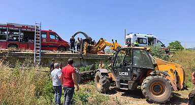 Köprüden düşen traktörün altında kalan sürücü iş makinesiyle kurtarıldı